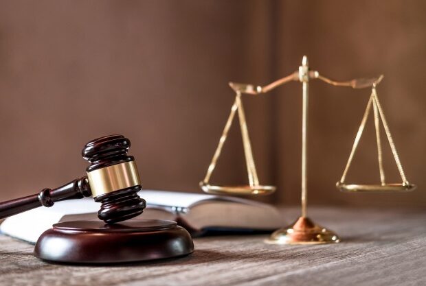 image-scales-of-justice-and-gavel-on-wooden-table-and-agreement-in-courtroom_28283-789